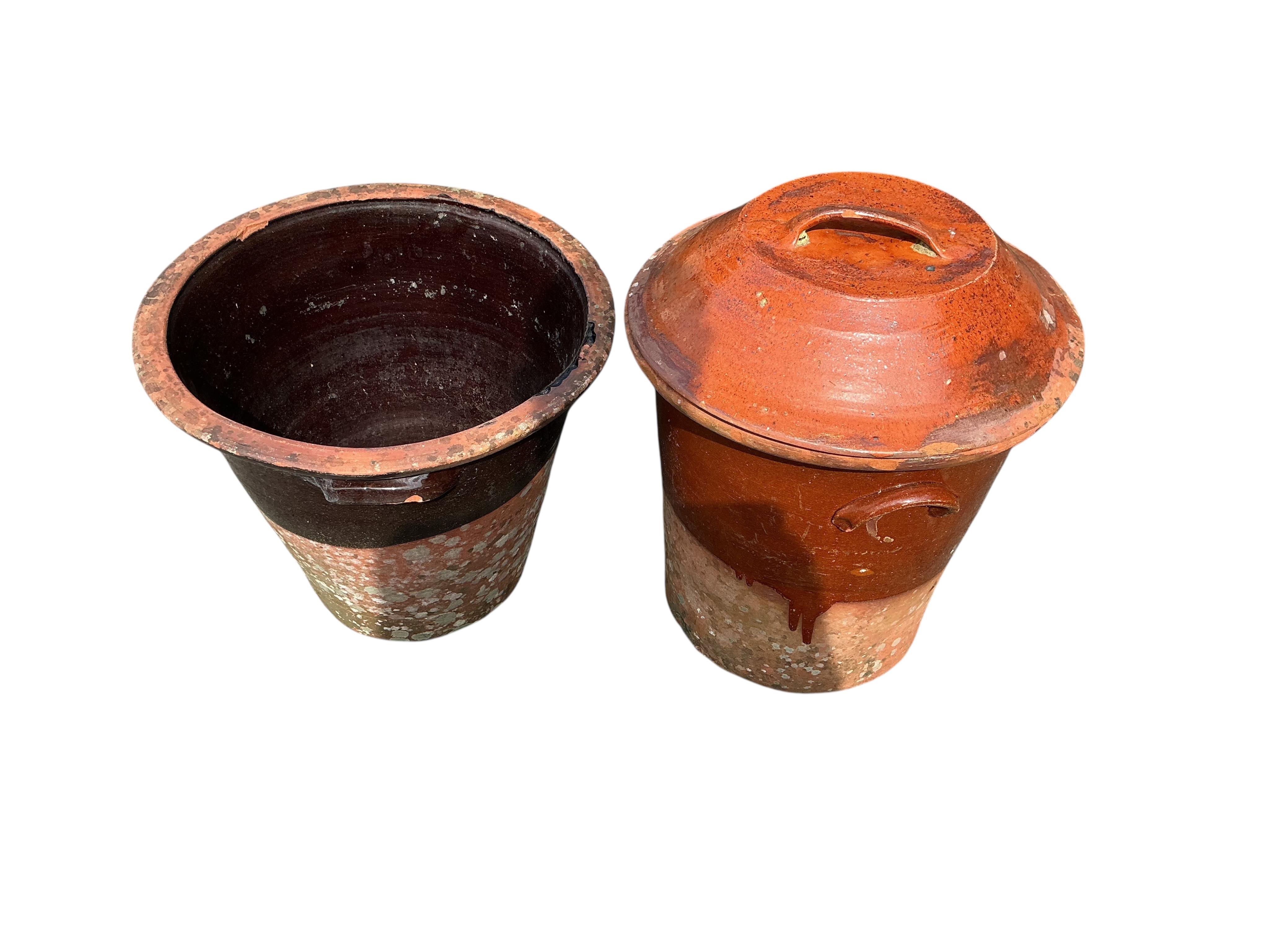 Four circular earthenware pails and planters, largest height 50cm